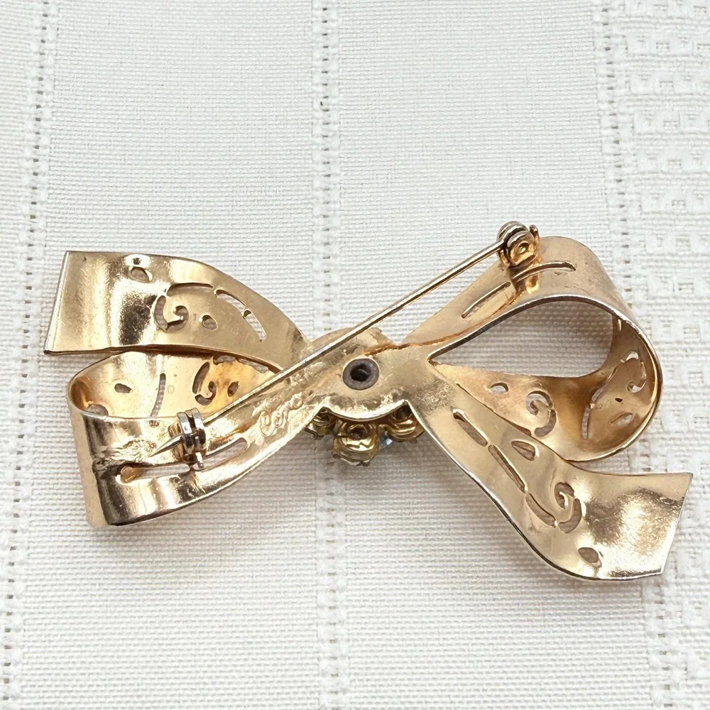Vintage CORO Gray and Blue Rhinestones Gold Tone Cutout Bow Pin Brooch